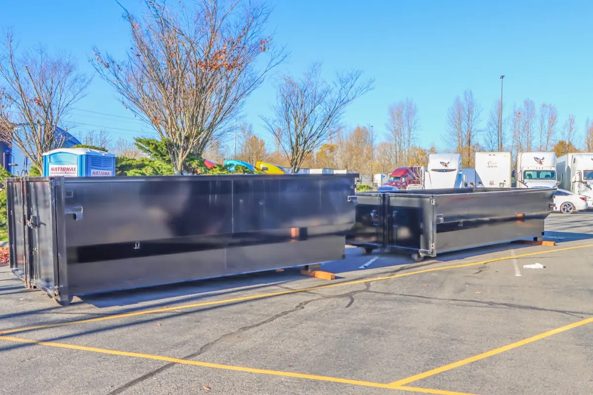 Professional dumpster rental service with roll-off container on residential driveway in Duluth